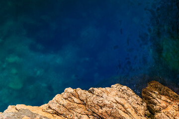 Turquoise water of the Mediterranean Sea and a cliff in Nice, South of France