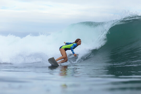 Side view of woman surfing on sea