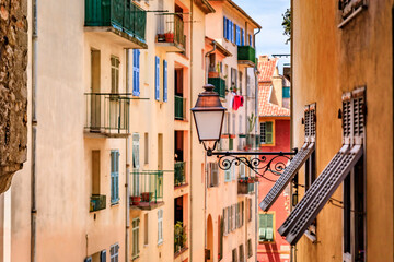 Fototapeta na wymiar Traditional old houses with wooden shutters in the streets of Nice, France