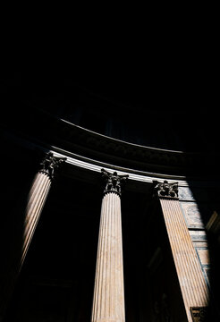 Low angle view of light falling on architectural columns of Pantheon during night