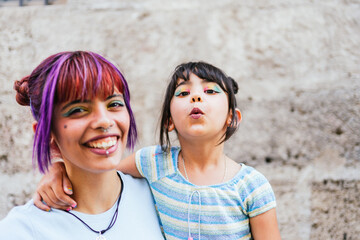 Portrait of a little girl and her mother smiling in the street