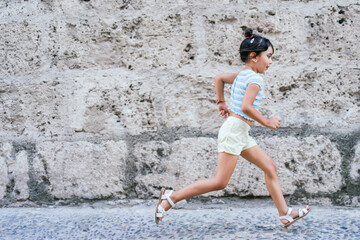 Little girl running in the street
