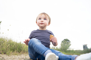 Low angle of a girl sitting on a rural path