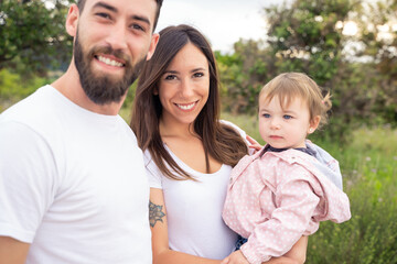 Portrait of a young caucasian family outdoors