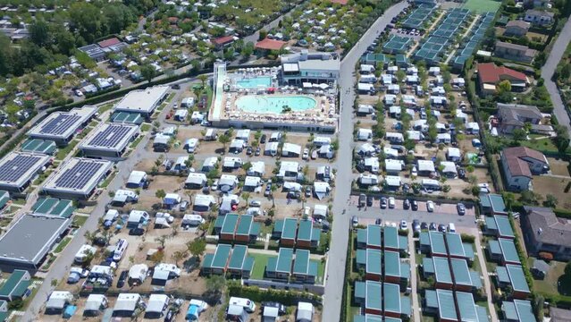 Campsite as far as the eye can see. Aerial tilt up view of Camping Idea Lazise. Lake Garda. 