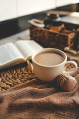 Cup of coffee and macarons, open bible in cozy home interior, good morning concept
