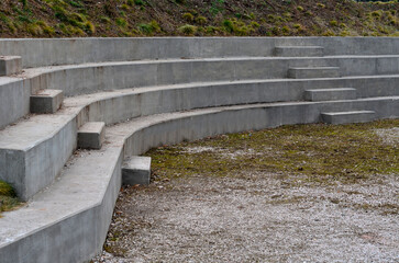 concrete staircase serves as a theater bench overlooking river. cobblestone cobblestones cubes on...