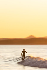 Fototapeta na wymiar Surfer on sunset panning shot
