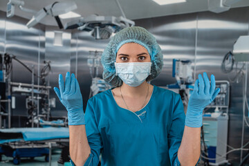 Obraz na płótnie Canvas nurse wears uniform with while putting rubber latex gloves during complex surgical operation.