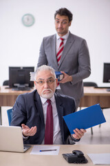 Two male colleagues working in the office