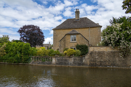 Burton on Water, UK, 28 june 2022. Wide angle views of the typical houses with shallow river in burton on the water small village in the Cotswold.