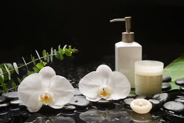 Lifestyle Healthy Concept, black stones setting for massage treatment and relax with white orchid  - 580549717