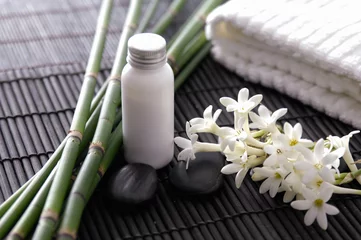 Foto op Plexiglas Healthy Concept, white flower ,oil bottle, towel, bamboo stem  , Spa with candle and stone spa on mat  © Mee Ting