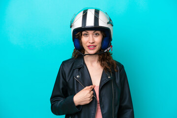 Young caucasian woman with a motorcycle helmet isolated on blue background with surprise facial expression