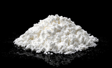 Fototapeta na wymiar Pile of powdered milk isolated on black background