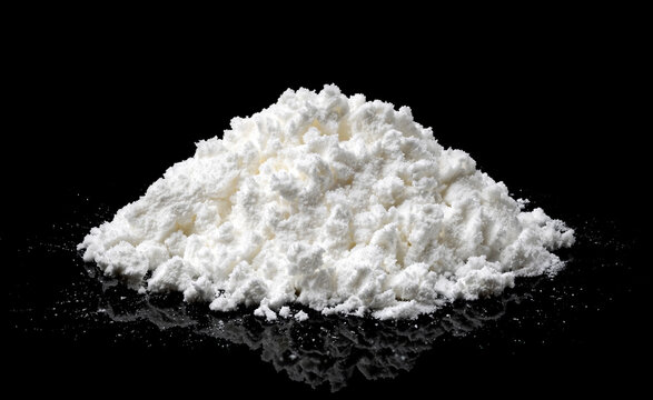 Pile of powdered milk isolated on black background