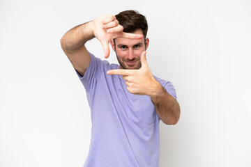 Young caucasian man isolated on white background focusing face. Framing symbol