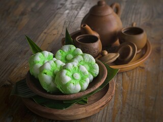 Putu Ayu, traditional cake or snack from Indonesia. Steamed cake with grated coconut. Wooden background.