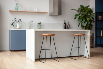 Modern kitchen interior in scandinavian style and gray tones. Kitchen island and bar stool....