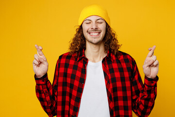 Young wistful fun caucasian man wearing red checkered shirt white t-shirt hat waiting for special...