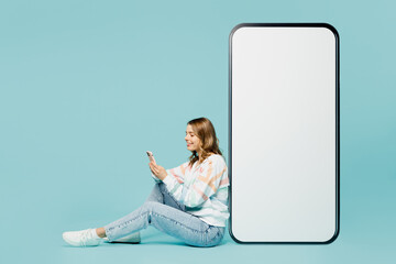 Full body young woman wear striped hoody big huge blank screen mobile cell phone with workspace...