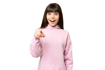 Little girl over isolated green chroma key background surprised and pointing front