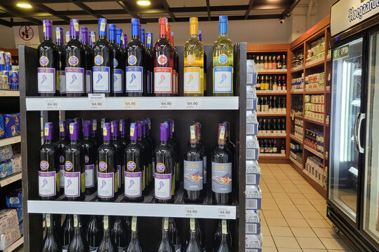PENANG, MALAYSIA - 9 MARCH 2023: An assortment of imported wine and hard liquor bottles display neatly on store shelves in Giant Grocery store, Malaysia.