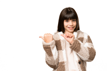 Little girl over isolated green chroma key background pointing to the side to present a product