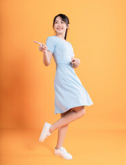 Young Asian woman wearing dress on background