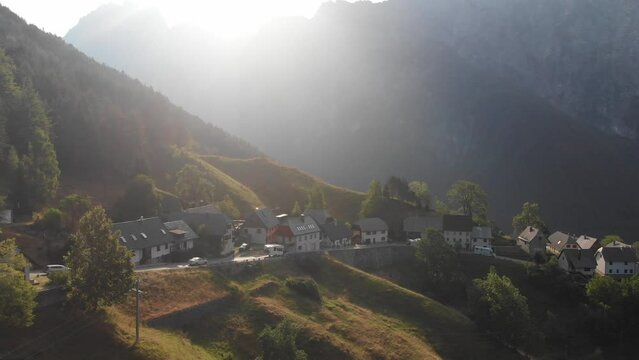 aerial view of Strmec village in Triglav national park, campers and cars driving