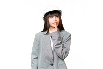 Little girl playing as a architect with helmet and holding blueprints over isolated background having doubts while looking up