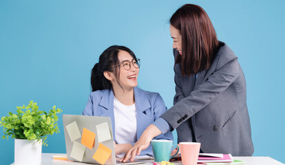 Two Asian businesswoman working background