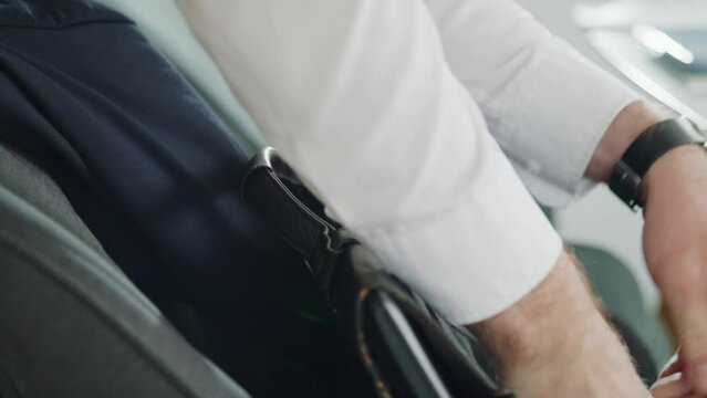 putting a notebook into a briefcase to get ready for work