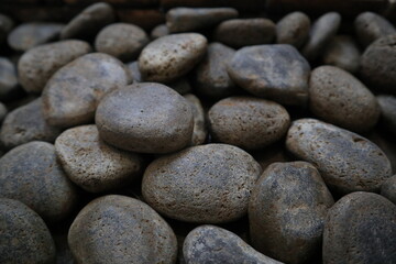 Fototapeta na wymiar pile of round gray stones from water pond for texture background