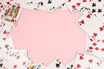Poker playing cards on pink background