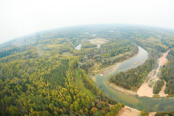 Aerial wide angle photo of bends of river through forest. Latvia, Gauja river