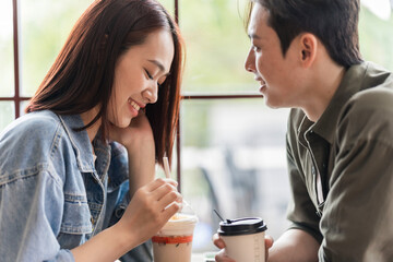 Young Asian couple dating at coffee shop
