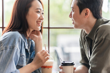 Young Asian couple dating at coffee shop