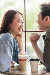 Young Asian couple dating at coffee shop