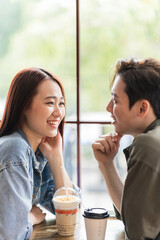 Young Asian couple dating at coffee shop