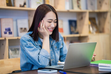 Young Asian girl studying at library