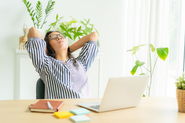 Asia woman touching massage stiff neck after sedentary computer work in incorrect posture