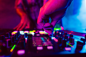 Fototapeta na wymiar Close up of DJ hands on dj console mixer during concert in the club
