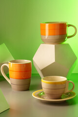 Colorful clay ceramic cups on gray background