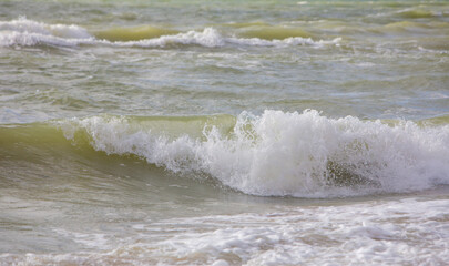 White waves crashing water surface in stormy water weather