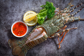 spiny lobster sashimi seafood, fresh lobster or rock lobster with herb and spices lemon parsley on...