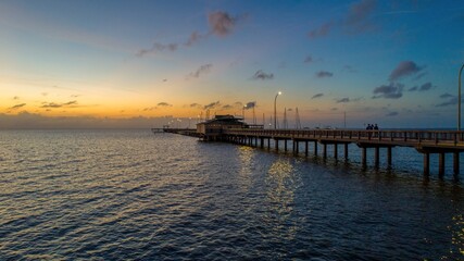 Fototapeta na wymiar The Fairhope Municipal Pier on Mobile Bay at sunset