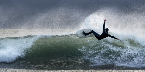 Surfing falling with surfboard in sea