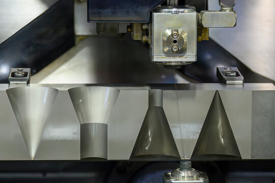 Closeup scene the wire EDM machine cutting the mold insert parts.