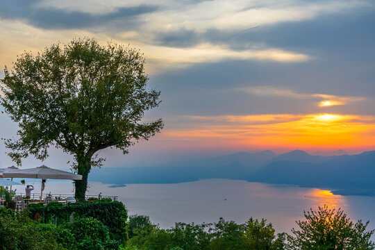 Italy, Veneto, San Zeno di Montagna, Lake Garda at cloudy sunset
